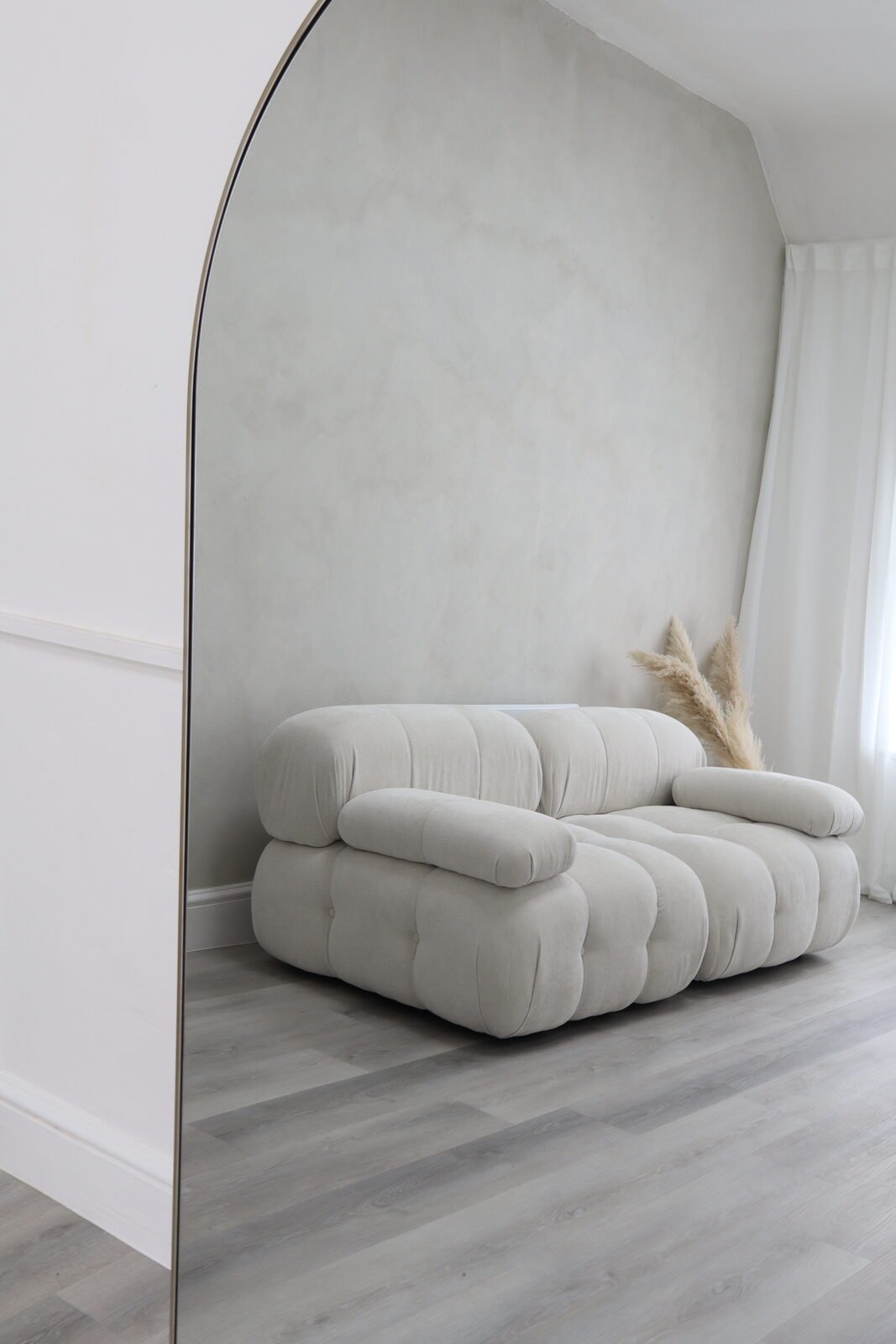 Cloud Grey Studio interior with sofa and arched mirror